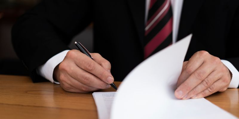 lawyer signing paperwork