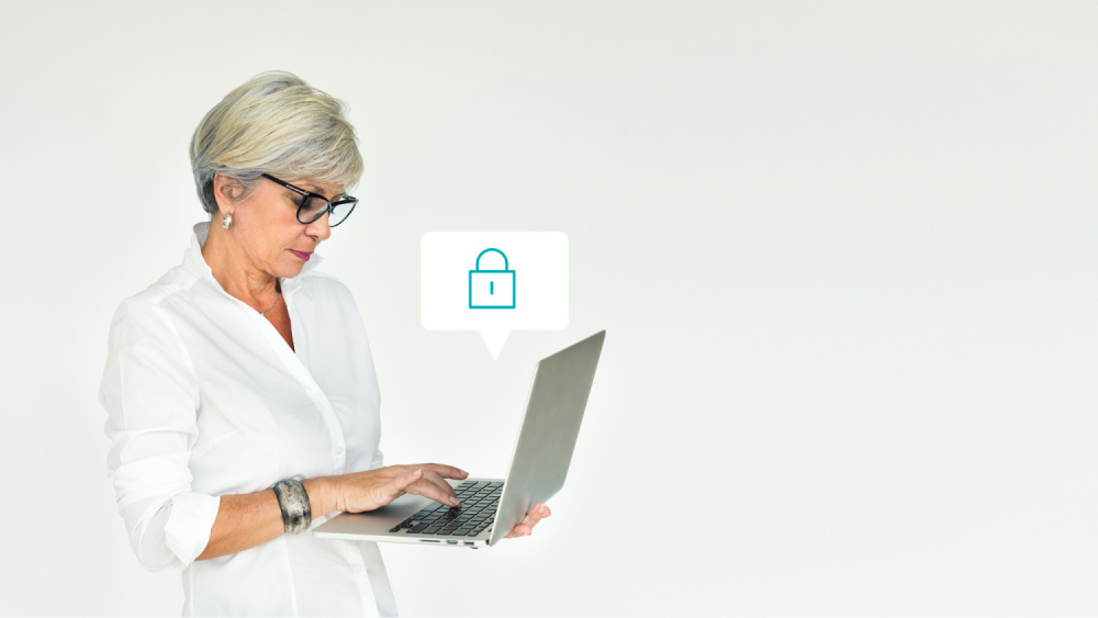 Woman typing on laptop with lock icon.