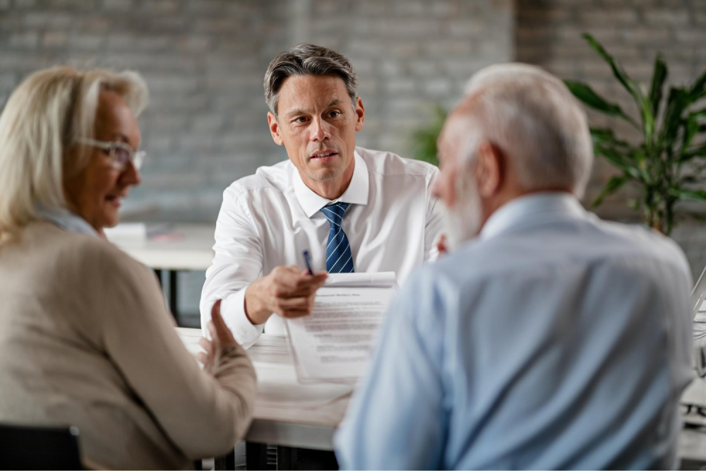 Financial advisor consulting elderly couple.