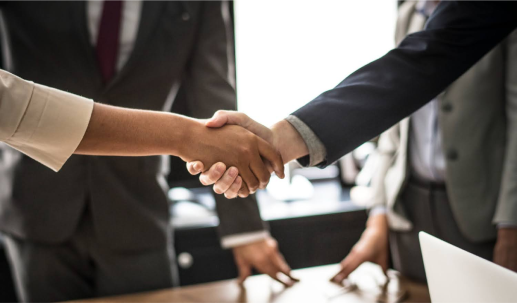 Close-up of a handshake between two professionals, symbolizing agreements or legal transactions related to estate matters.