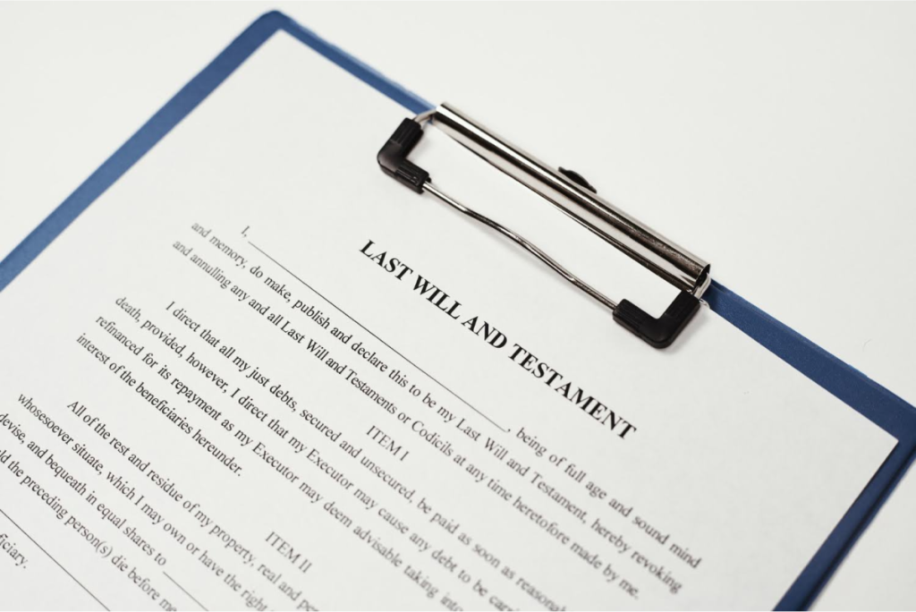 A close-up of a legal document titled "Last Will and Testament" on a clipboard, symbolizing the preparation of important estate documents.